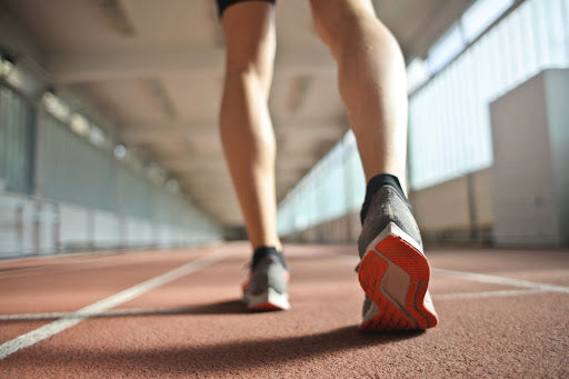Mans shoe running on indoor track