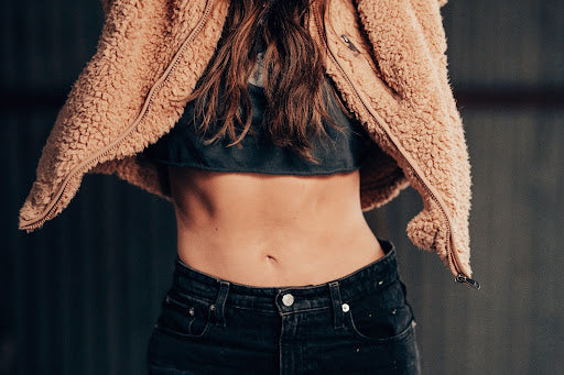 Woman wearing crop top showing stomach.